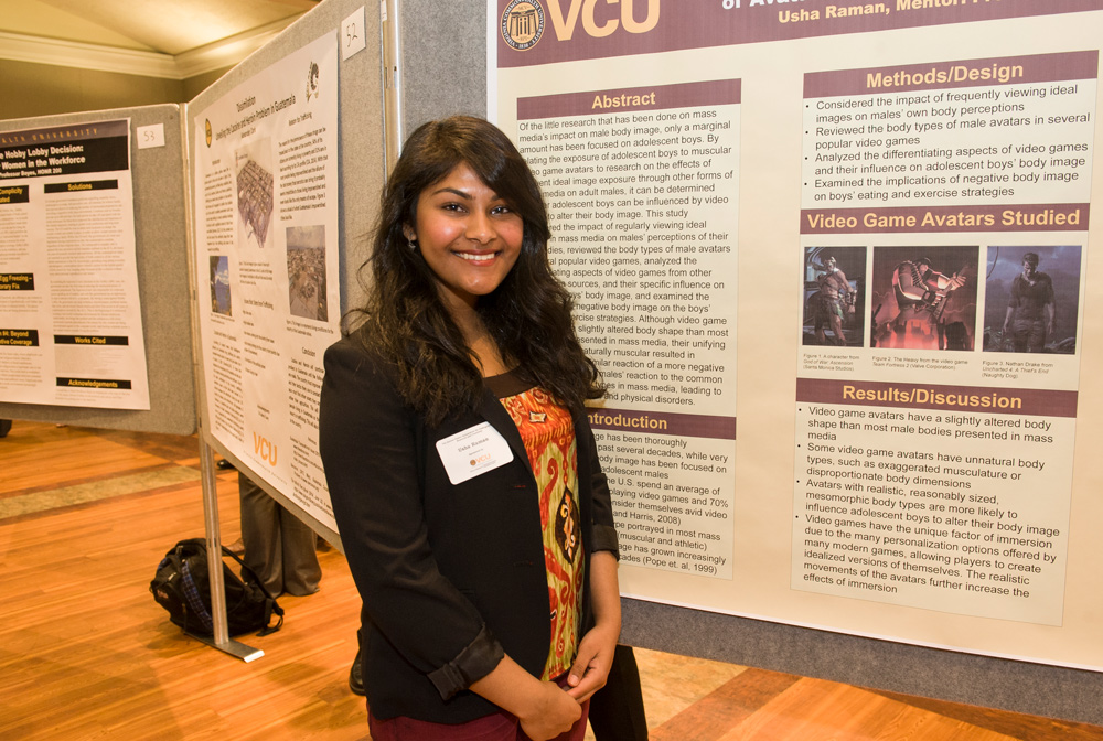 A student presents a poster at a research symposium